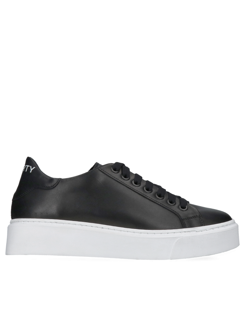 Fashionable black grain leather sneakers on white thick sole