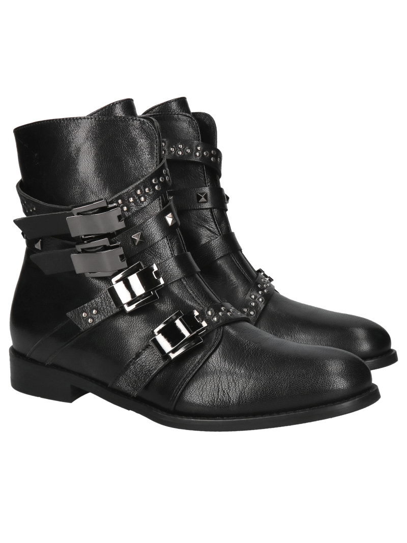 Original and unique women's insulated boots with decorative buckles, leather winter boots from a Polish manufacturer.