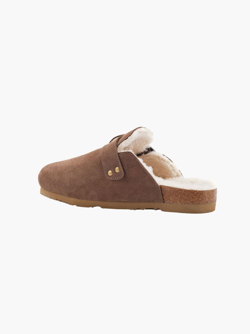 Soft suede clogs with a side buckle. Comfortable sheepskin insole and molded sole.