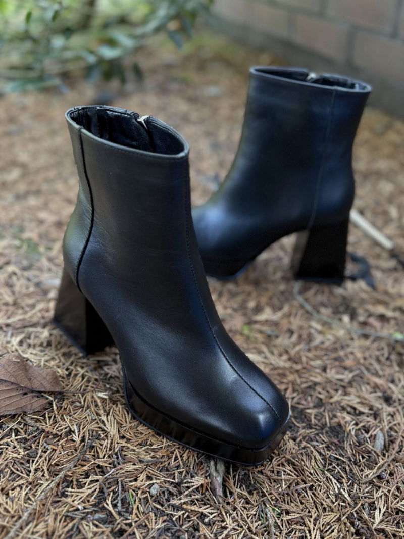 Fashionable women's boots with thick heels, elegant boots made of grain leather