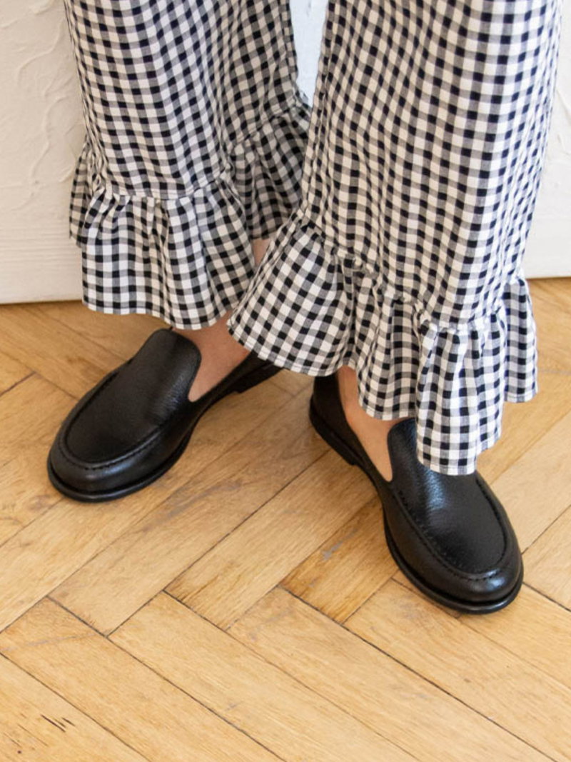 Soft, slip-on women's black full-grain leather loafers with a round toe