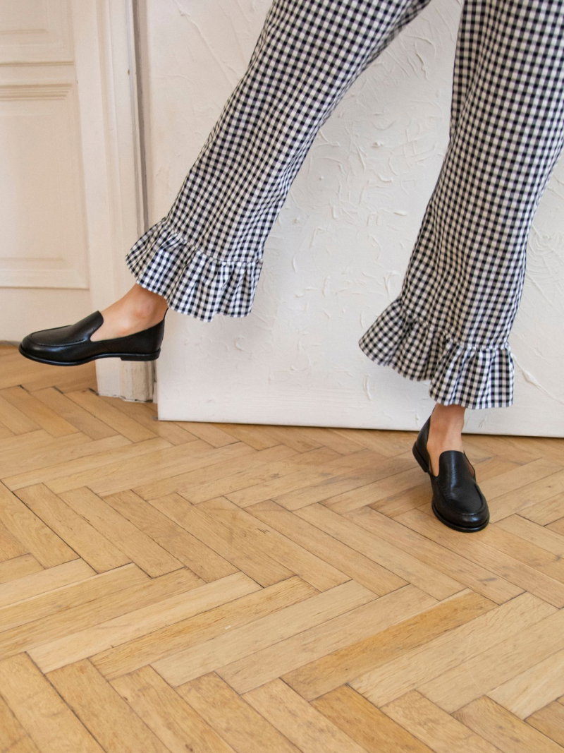 Soft, slip-on women's black full-grain leather loafers with a round toe